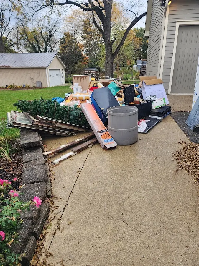Dumpster being loaded with debris for 3 Yard Dumpster Rental in Hartland